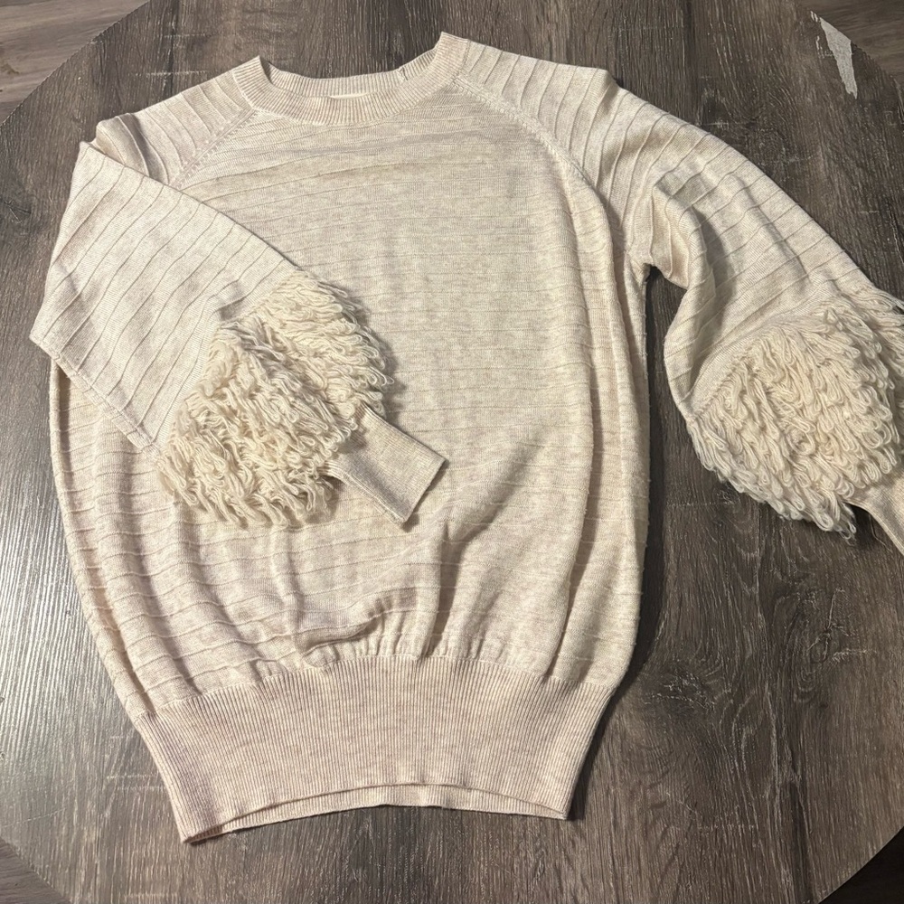 THE GREAT. Cream Crewneck Sweater with Fringe Sleeve Detail